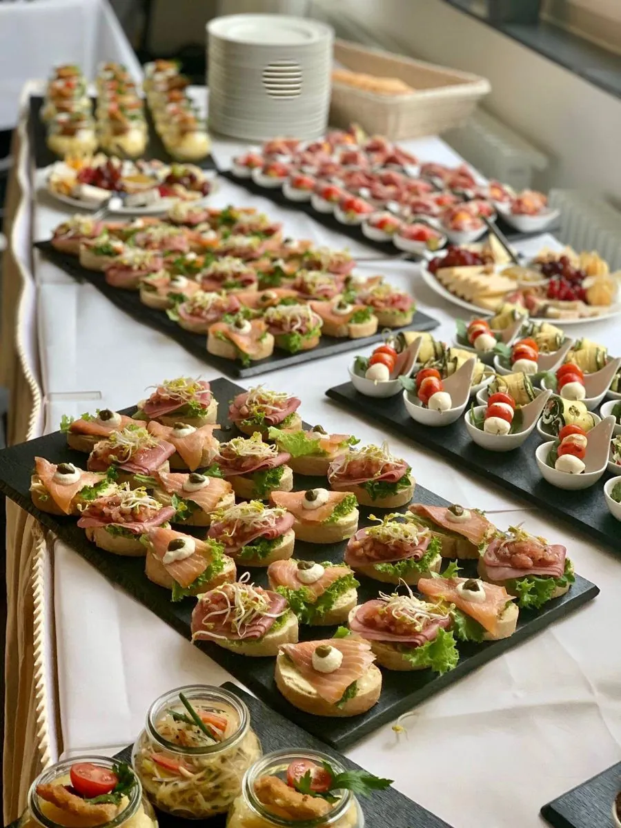 Trays of canapés on slate boards at a catered event